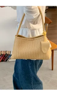 Beige woven leather shoulder bag, stylish commuter underarm handbag with chic braided design.
