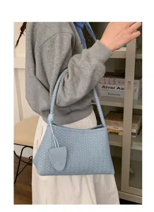 Light blue woven leather shoulder bag detail showing premium texture and knot accent.