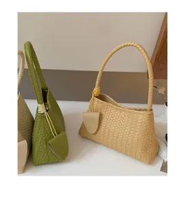 Woven leather underarm bag detail, chic women shoulder handbag with stylish braided handle.