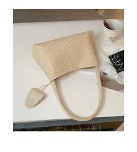 Chic beige woven leather shoulder bag for women, stylish underarm bag for daily commute.