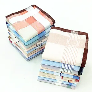 Detail view of stacked cotton men's plaid and striped handkerchiefs, soft 100% cotton fabric.