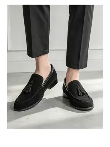 Close-up of men's black suede tassel loafers showing detailed texture and slip-on style.