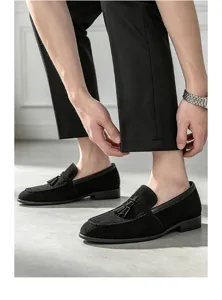 Men's black suede tassel loafers, classic slip-on design with comfortable low heels.
