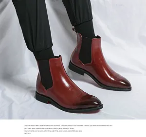 Detail view of men's leather Chelsea boots featuring pointed toe and elastic side gore.