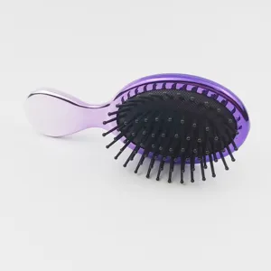 Brosse à cheveux violette électrodéposée compacte avec picots de massage à coussin d'air quotidien.