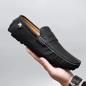 Classic black leather loafers for men and women, comfortable slip-on driving moccasins.