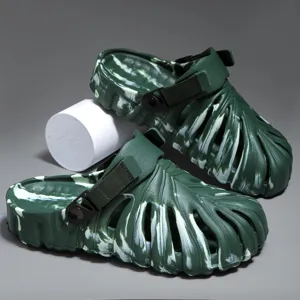 Green hollow clogs with unique leaf texture design, adjustable strap for casual summer wear.