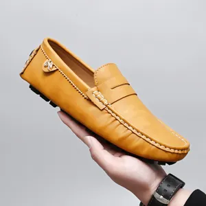 Men's yellow leather casual slip-on driving loafer detail showing stitching and side charm.