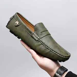 Men's casual olive green leather driving shoes loafer detailed shot showing stitching and logo.