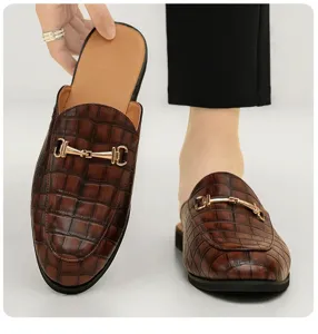 Men's brown crocodile pattern leather backless mules featuring a sleek metal horsebit detail.