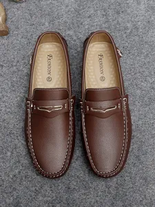 Detail shot of brown leather men driving loafers moccasins with contrast white stitching.