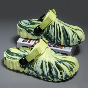 Green camo clogs sandals with adjustable strap and hollow-out leaf texture, detail view.