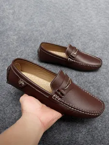 Men's brown leather driving loafers, slip-on casual shoes with metal bit and white stitching.