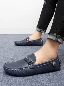 Men casual driving loafers slip on shoes detailed view, dark blue leather footwear with white stitching.
