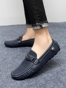 Detail view of men's navy blue casual driving loafers with white stitching and metal decor.