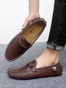 Classic brown leather men driving shoes with slip-on design and comfortable flat sole.