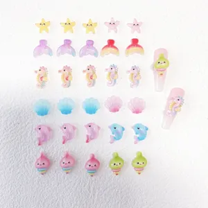 Detailed close-up of colorful resin ocean animal charms for DIY nail art and phone case crafts.