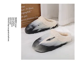Close-up detail of winter plush warm indoor slippers with abstract black and white pattern.