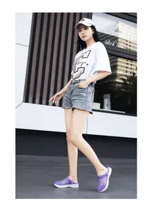 Detail view of stylish purple thick-soled clogs, anti-slip jelly beach sandals for summer.