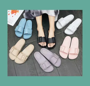 Comfortable flat slide sandals with large buckle detail, perfect for casual summer wear.