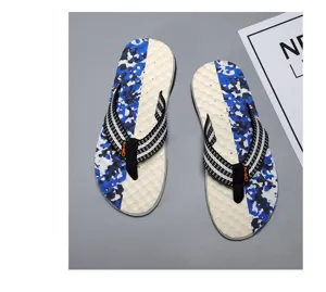 Men summer beach flip flops with blue camouflage sole and striped straps detail view.