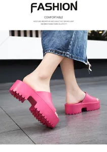 Close-up view of the chunky pink platform slide sandals, showing detailed thick textured soles.