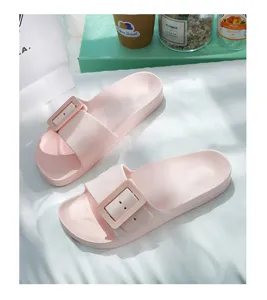 Close-up detail of pink flat slide sandals featuring a stylish square buckle for women.
