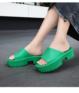 Detailed view of women summer green chunky platform slide sandals with thick sole.