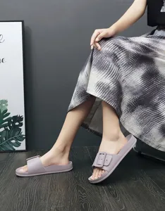 Purple slide sandals with decorative buckle detail for casual summer wear and daily comfort.