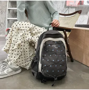 Grey and beige backpack with blue heart embroidery, stylish school bag for daily commute.
