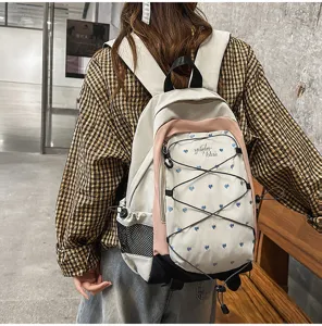 Cute heart print white pink backpack sweet cool style casual school bag for daily commute.