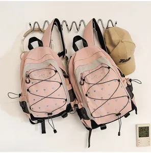 Pink cute student backpack with blue heart print, stylish campus commuter bookbag.