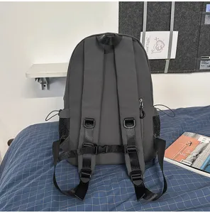 Dark grey casual backpack with adjustable straps and side mesh pockets for daily commute.