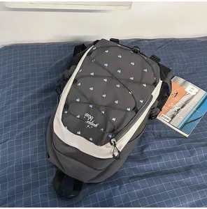 Sweet cool style backpack with blue heart print, grey and white design for daily student use.