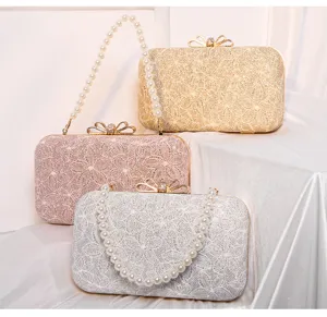 Detailed view of evening clutch bags showcasing sparkling lace texture and pearl chain handles.