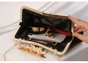 Detailed view of rhinestone evening clutch interior capacity, black lining, metal frame.