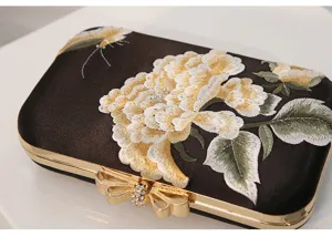 Elegant embroidered evening clutch bag with peony flower and gold bow clasp for women parties.