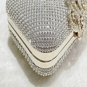 Stunning rhinestone evening clutch bag with luxury crystal details and metallic frame for parties.