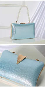 Stunning light blue glitter evening clutch with elegant pearl handle and gold leaf clasp.