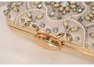 Close-up detail of handcrafted evening clutch with intricate beads, pearls, and sparkling rhinestones.