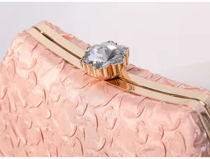 Elegant pink evening clutch bag with gold metal frame and sparkling crystal flower clasp.