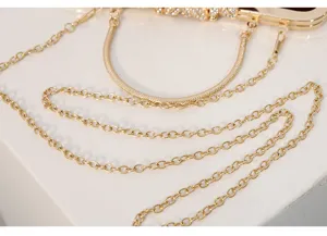 Gold evening bag metal chain rhinestone handle detail close up elegant clutch accessory