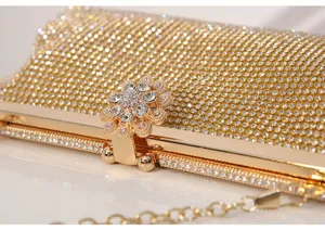 Detailed view of the sparkling rhinestone evening clutch, featuring a stunning flower clasp.