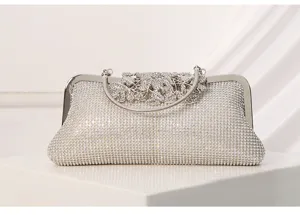 Silver rhinestone evening clutch bag with metallic frame and gorgeous floral clasp design.