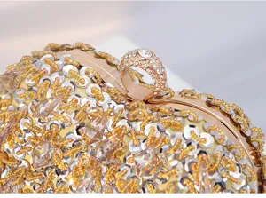 Detailed closeup of exquisite beaded crystal heart evening clutch bag with gold metallic frame.