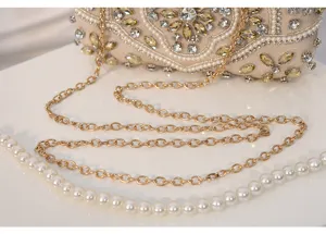 Detailed view of handmade beaded rhinestone evening bag clutch with gold chain strap elegance.