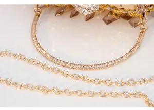 Gold beaded crystal evening clutch bag detail view, luxury metallic prom party purse.
