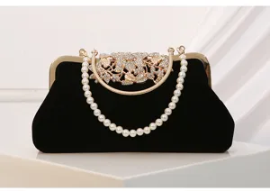 Black velvet evening bag with pearl handle and rhinestone leaf clasp for banquet party.
