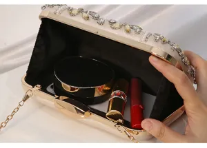 Detailed view of handmade beaded rhinestone evening clutch bag with chain strap and spacious interior.