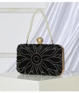Black rhinestone evening clutch bag with pearl handle and floral crystal design for women.